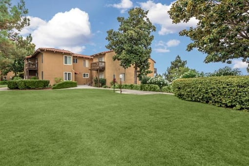 A large grassy area in front of a building.