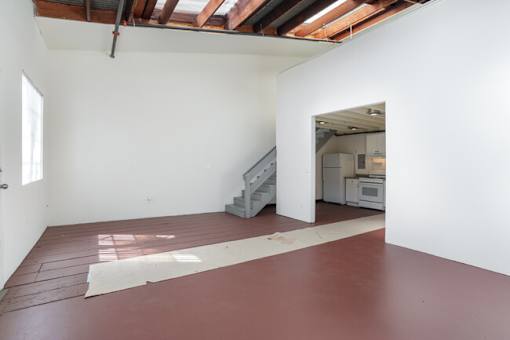 A room with a red floor and white walls.