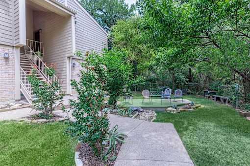 A house with a well-kept garden in front.