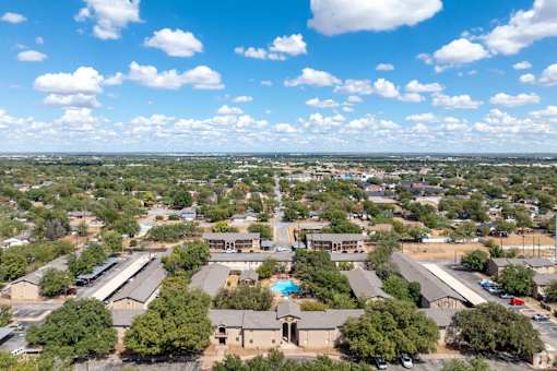 an aerial view of a city with houses and trees