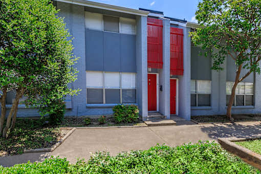 the front of a building with a red door