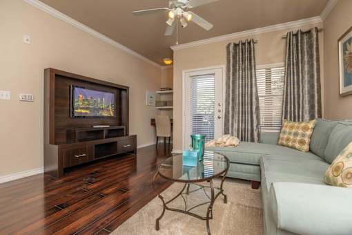 A living room with a television, couch, and coffee table.