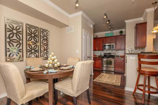 A dining room with a table set for four.
