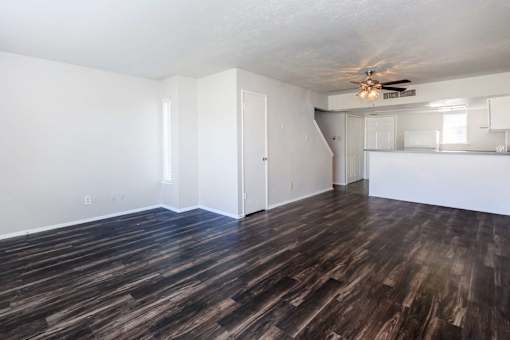 a living room with a hard wood floor and a ceiling fan