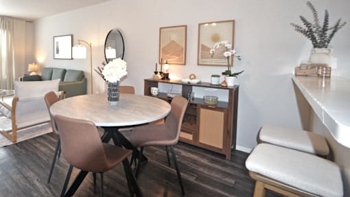 A dining room with a round table and chairs.