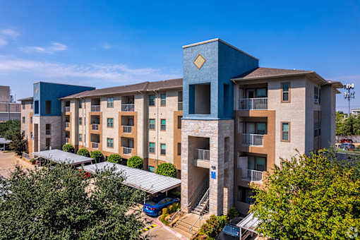 A modern apartment complex with a blue building in the foreground.