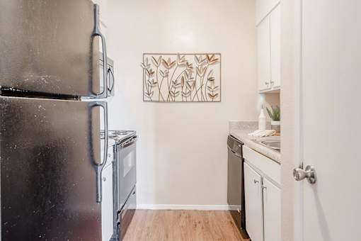 a kitchen with a refrigerator and a stove and a sink