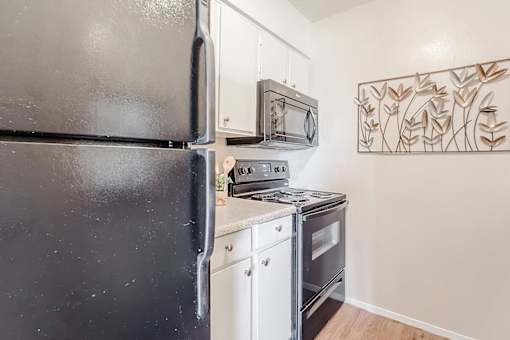 a small kitchen with a stove and a refrigerator