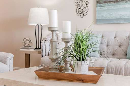a living room with a table with candles and a couch