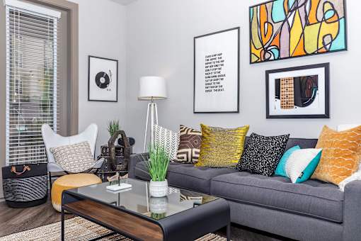 a living room with a gray couch and a coffee table