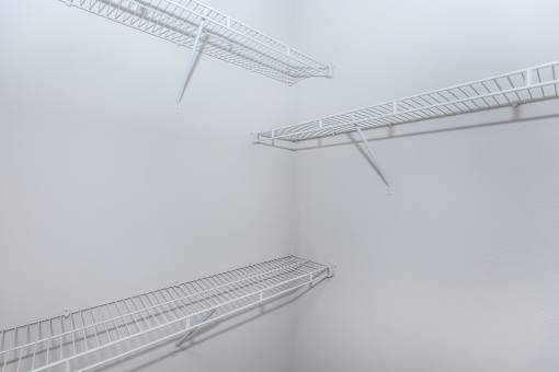 three white shelves on a wall in a foggy room