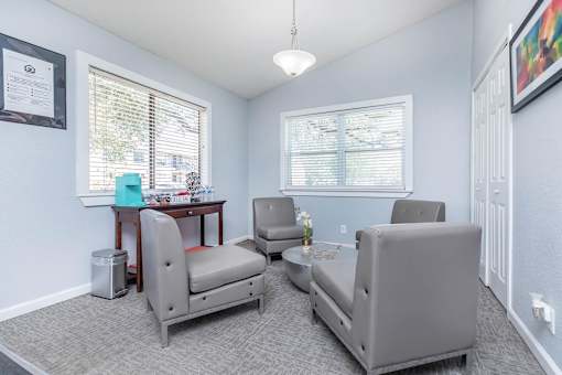 a living room with couches and chairs and a table