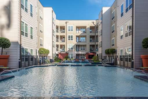 a swimming pool in front of an apartment building