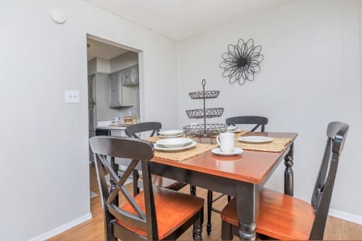 a dining room with a wooden table and chairs