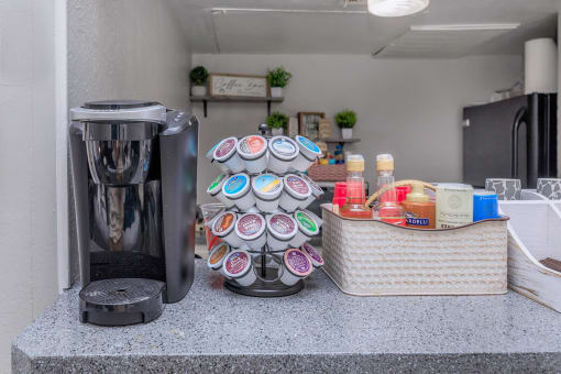 a coffee maker and a basket on a counter in a kitchen