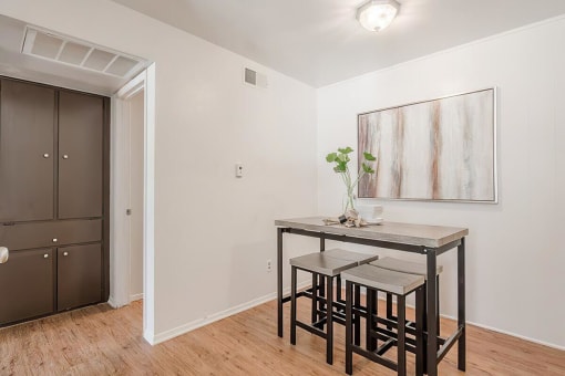 a dining room with a table and three stools