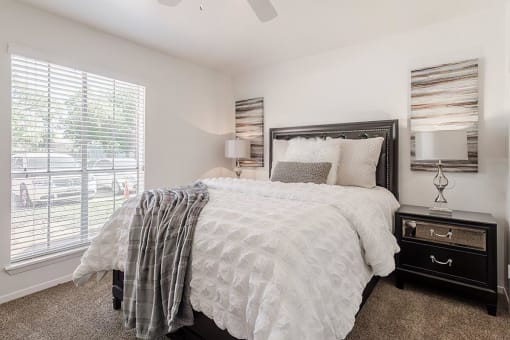 a bedroom with a bed and a window