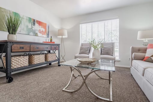 a living room with a couch and a glass table
