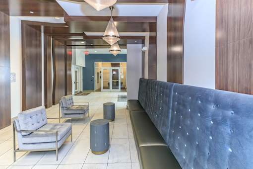 a lobby with a blue couch and chairs
