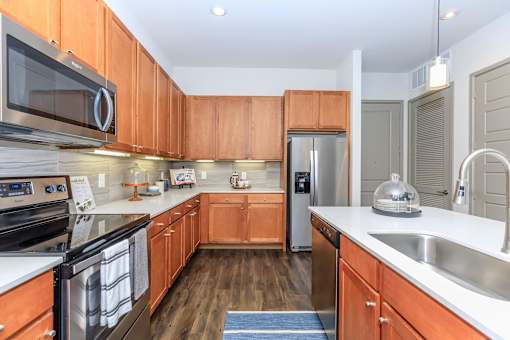 a kitchen with wooden cabinets and stainless steel appliances