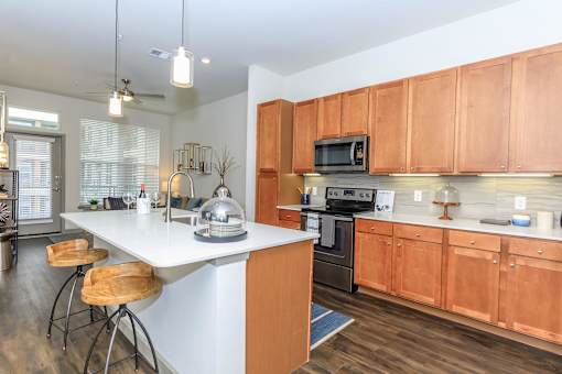 a kitchen with wooden cabinets and a white counter top