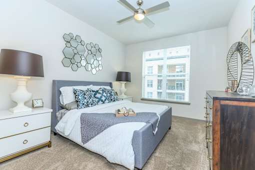 a bedroom with a bed and a ceiling fan