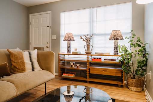 a living room with a couch and a coffee table and a window
