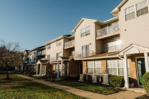 a row of houses with a sidewalk in front of them