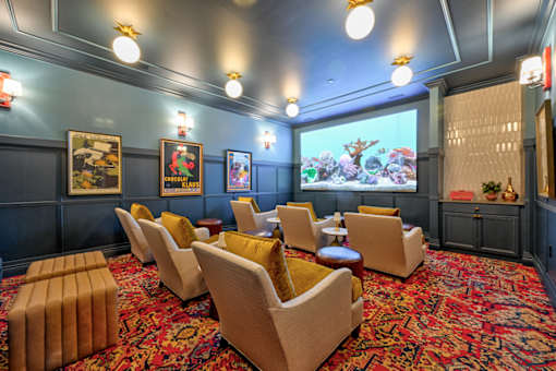A room with a carpet and chairs.