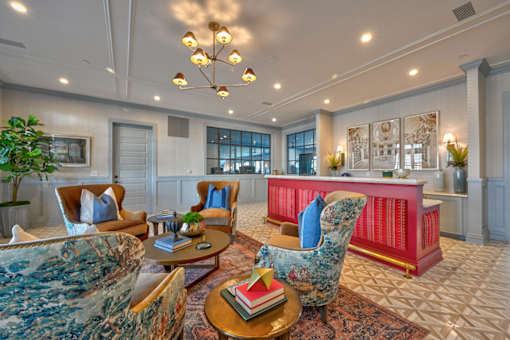 A living room with a red couch and a blue chair.