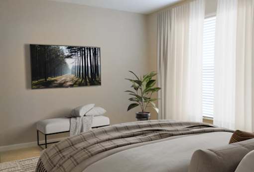 a bedroom with a bed and a painting on the wall