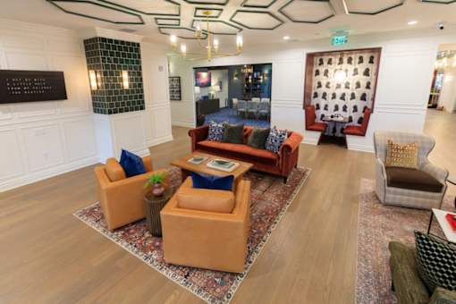 A living room with a sofa, armchairs, and a coffee table.