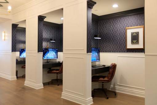 A room with a desk and a computer monitor.