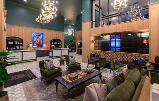 A large room with a long couch and a coffee table in the middle.