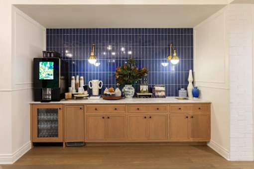 A kitchen with wooden cabinets and a blue tiled backsplash.