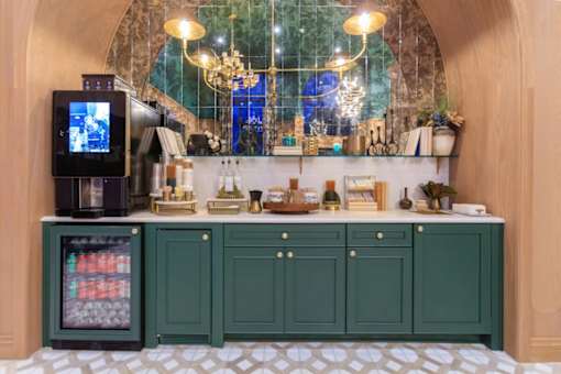 A bar area with a green cabinet and a television on the counter.