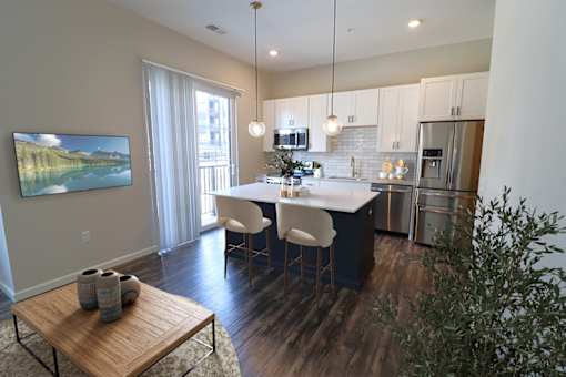 A modern kitchen with a dining table and chairs at Essex, Columbus, OH