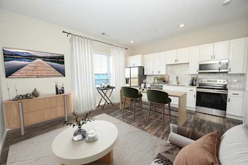 A modern kitchen with a dining area and a living room at Essex, Columbus, OH