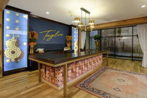 A reception area with a Taylor sign on the wall.