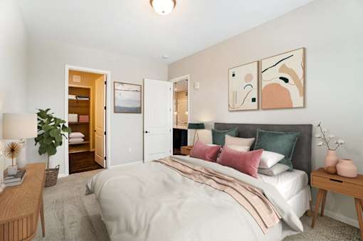 a bedroom with a bed and a door to a bathroom at Essex, Columbus, Ohio, 43212