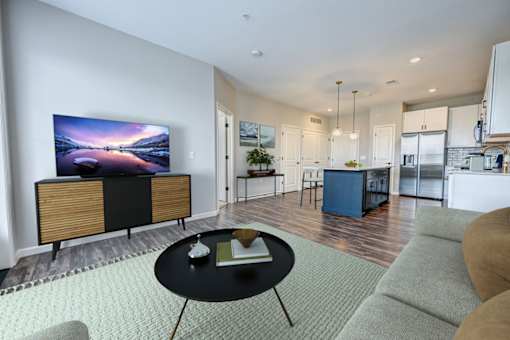 A modern living room with a flat screen TV and a coffee table at Essex, Columbus, OH