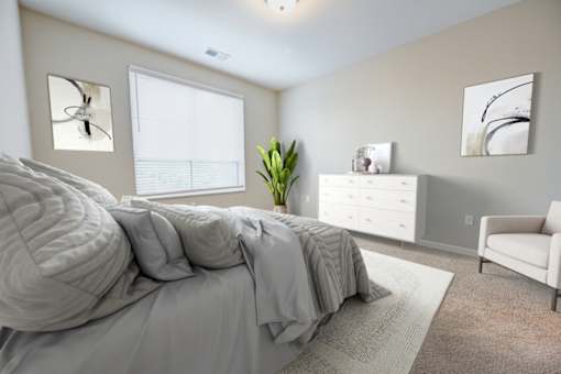 A bedroom with a large bed, a white dresser, and a white chair at Essex, Columbus, OH