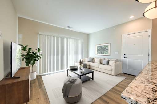 A living room with a couch, a television, and a plant.