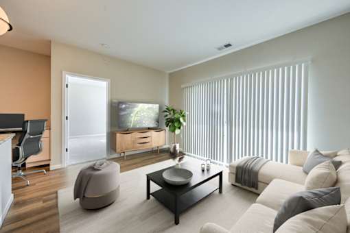 A modern living room with a large window and a flat screen TV.