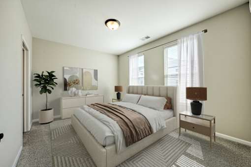 A bedroom with a large bed and a plant.