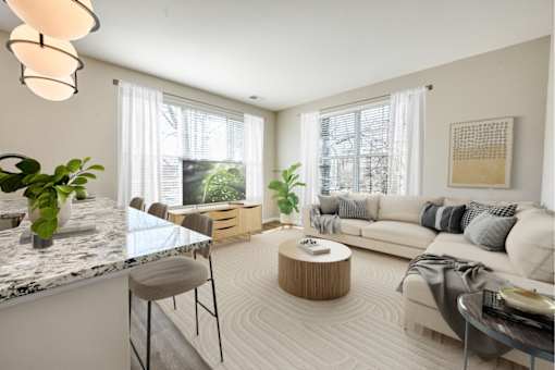 A modern living room with a marble countertop and a large window.