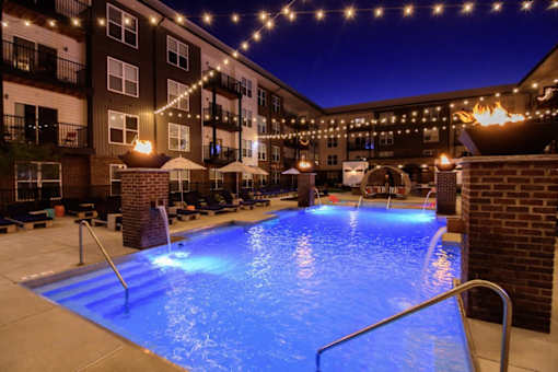 A lit up pool area at night.