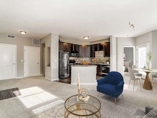 A modern kitchen with a blue chair in the foreground.