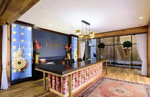 A Taylor branded kitchen with a black counter top and a wooden floor.