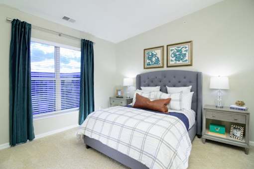 a bedroom with a large window and a bed at Taylor House Apartments, Columbus, OH, 43214
